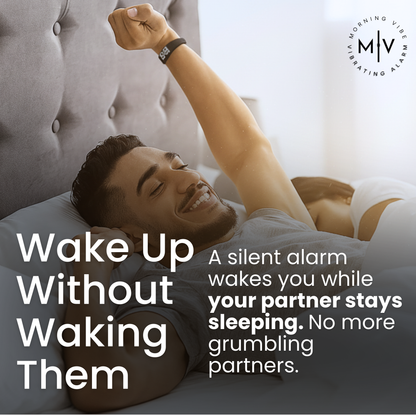 A smiling man stretches in bed while a woman sleeps beside him. Text promotes the Morning Vibe Vibrating Wrist Alarm, which gently vibrates to wake one person without disturbing their partner.